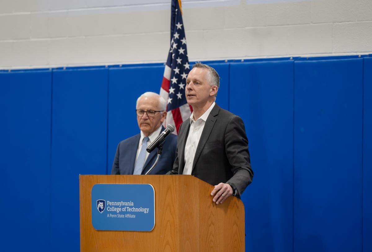 A man stands behind a podium.