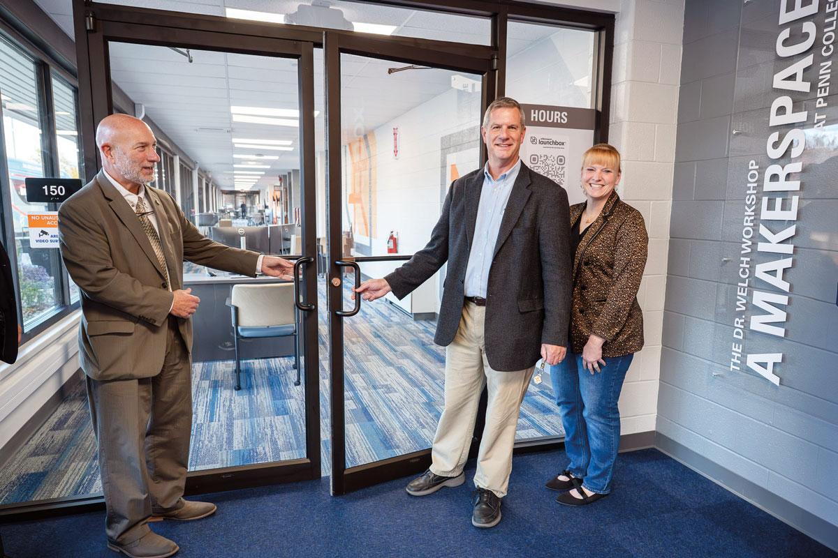 At an event to dedicate the Williamsport LaunchBox, Richard Vilello (left), deputy secretary of community affairs and development for the Pennsylvania Department of Community and Economic Development, joins Ken and Kristie Healy, who provided financial support for the LaunchBox, in ceremonially opening the facility's doors.