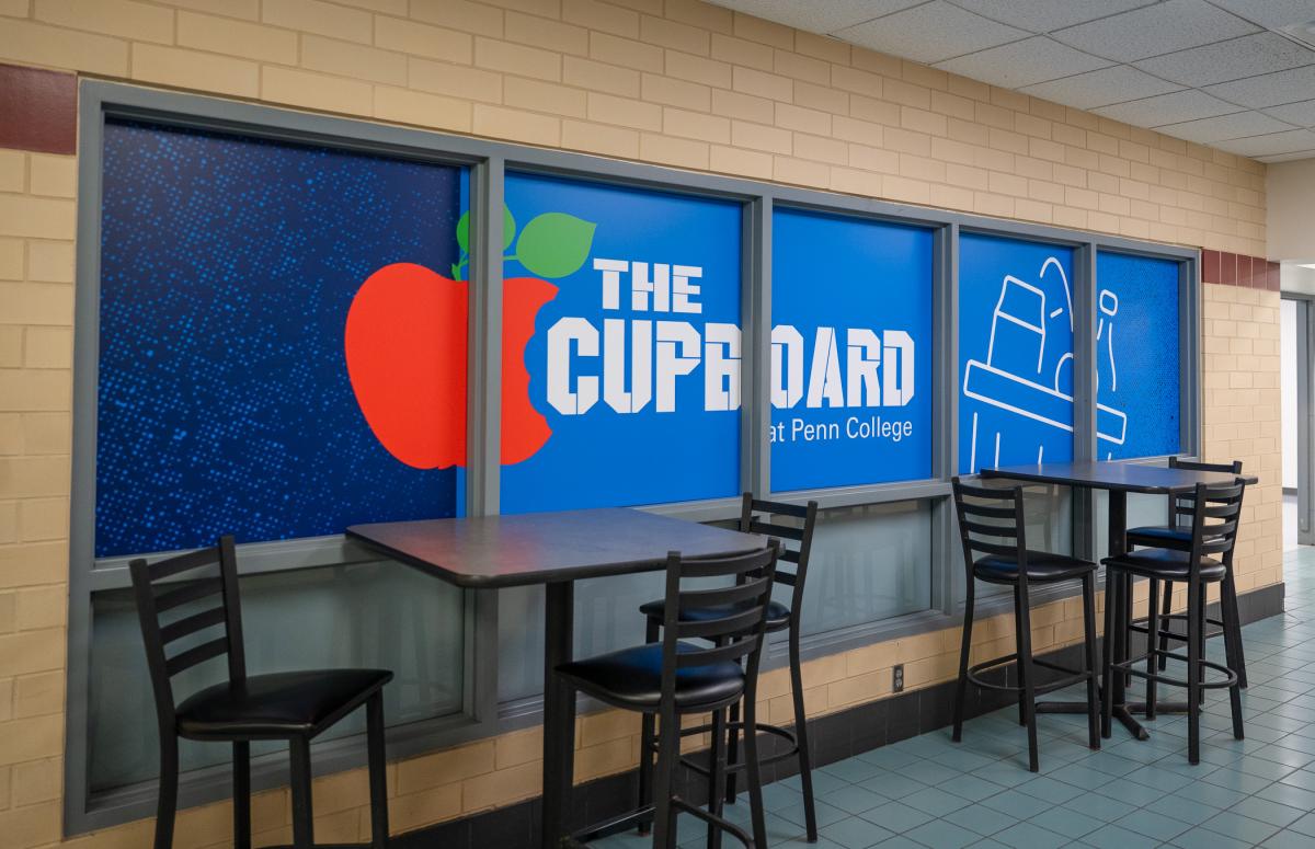 Windows of The Cupboard at Penn College with the facility’s logo.