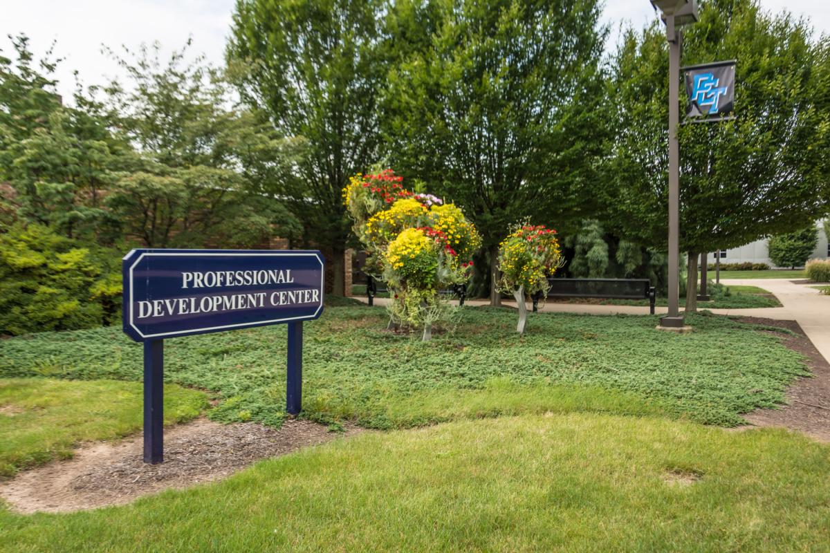 The entrance to the Thompson Professional Development Center surrounded in greenery