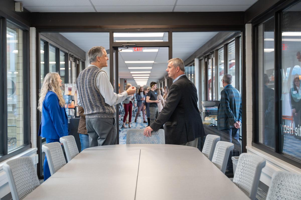 A small group holds a conversation in the Williamsport LaunchBox conference room