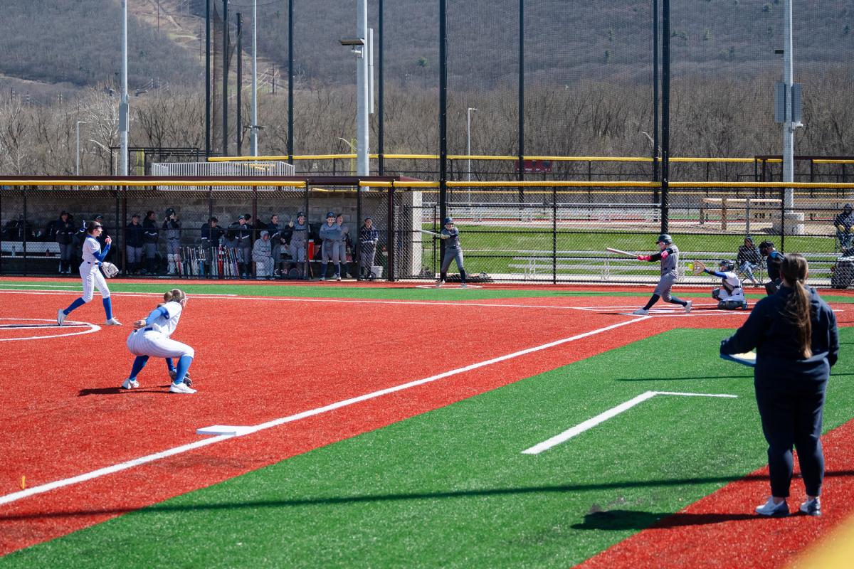 Looking down third-base line as Penn College softball pitcher strikes out Penn State Abington batter at Williamsport Lumber Yards.