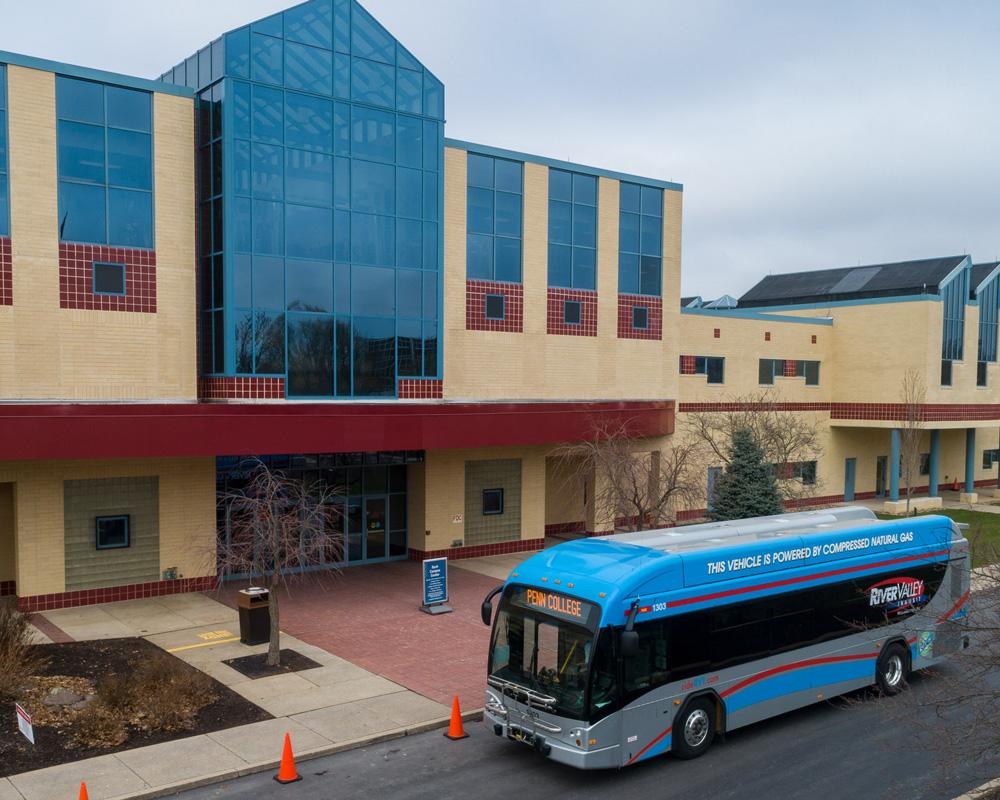 A bus parked in front of the Bush Campus Center