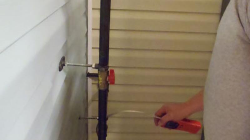 Mock-up homes are equipped inside and outside to demonstrate and assess Energy Auditor competencies, like checking for gas leaks during a home energy audit.