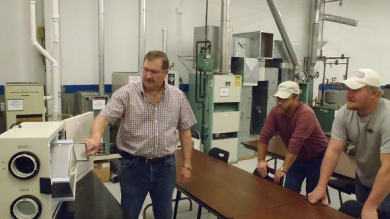 Clean Energy Center instructor Jack Wilson talks to a class about the components of a heat recovery ventilation unit.