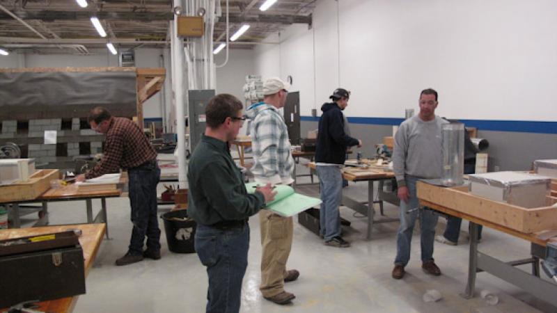 Students show off their projects during the hands-on portion of the Weatherization Tactics course.