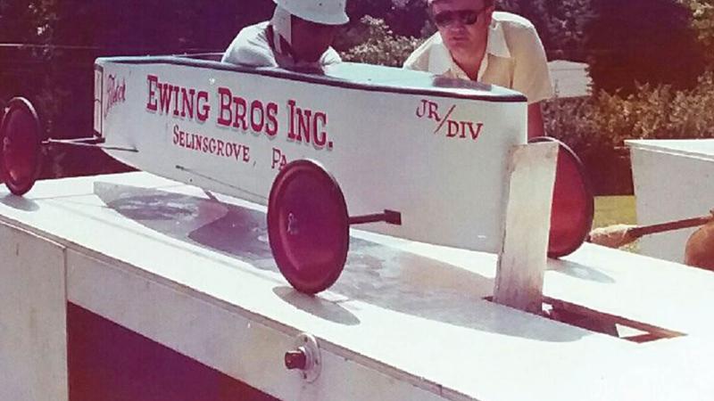 Ewing patiently waits for the start of a Soap Box Derby race at Bucknell University in the mid-1970s. At right is Ewing’s father, Dalas, who with his two brothers owned Ewing Brothers Inc., a custom home builders business. Ewing’s dad eventually branched off to form his own company: Ewing Building Products. 