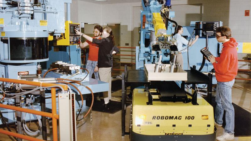 Robots tended automated machines in the manufacturing lab in 1986.