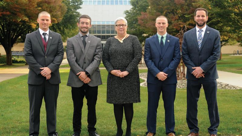  Hall of Famers. From left: Zachary Buterbaugh, Christopher Brennan, President Davie Jane Gilmour, Cody Buterbaugh and Matt Blymier, assistant director of athletics. This year’s fourth inductee, Teresa Burrill, was absent due to employment in Romania.