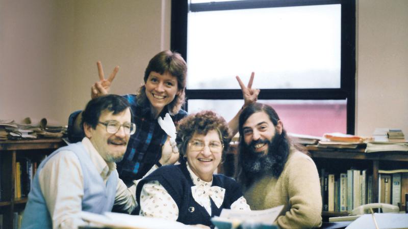 Kidding around with her English faculty officemates,  from left, Ned Coates, Lynn Hanson and Peter Dumanis.