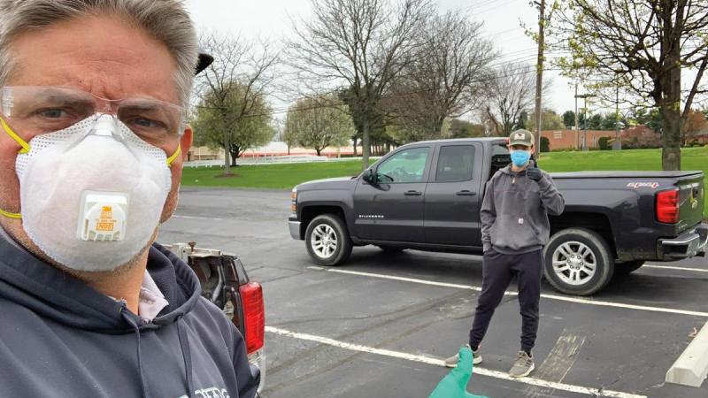 Delivering project materials to students, A well-traveled Chris Warren, instructor of building construction technology, completes a drop-off to student Jack Stahley in a vacant parking lot during a 500-mile trip to deliver project materials to students.