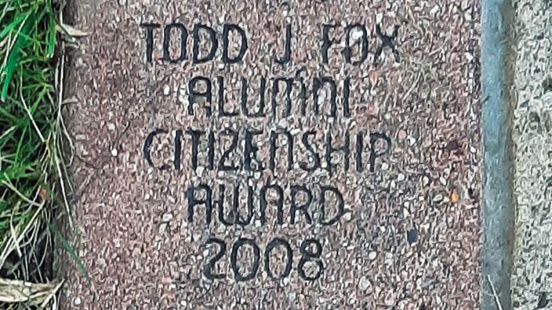 A brick along the sidewalk near Penn College's Main Entrance cements Fox's legacy as an alumni award winner.