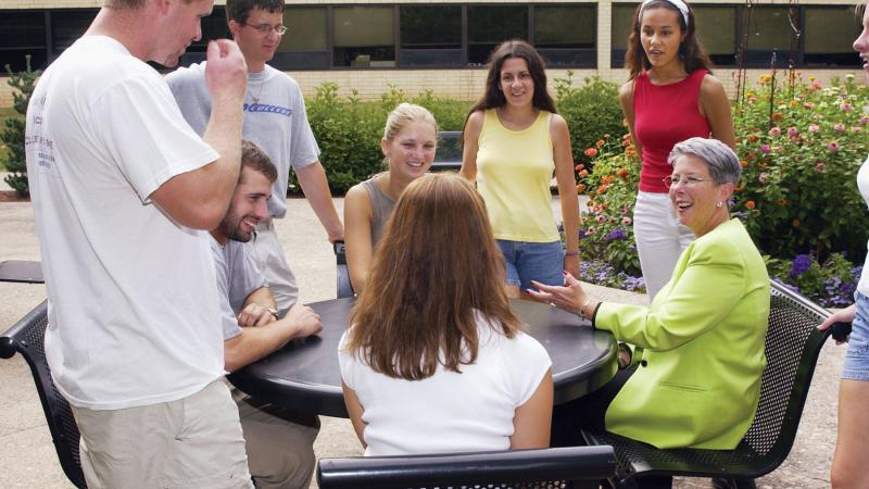 Gilmour meets with students near the Lifelong Education Center, 2002.
