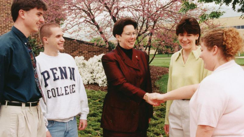 ... and meets with students on her first day as president in 1998.