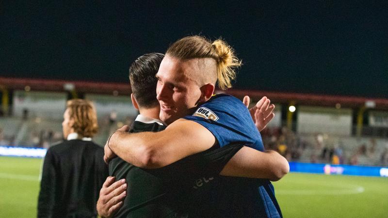Peters celebrates with Real Monarchs forward Aris Briggs, the 61st overall pick in the 2021 MLS SuperDraft.
