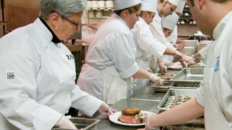 Gilmour joins culinary arts students in the prep line during a 2011 dinner to benefit the Tracy A. Garis Memorial Scholarship.