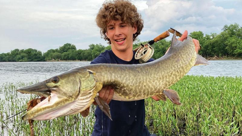 Reed’s favorite fishing buddy, Gavin, catches “the fish of a lifetime” – a 50-inch muskie – on a fly rod in the Susquehanna River in early June. 