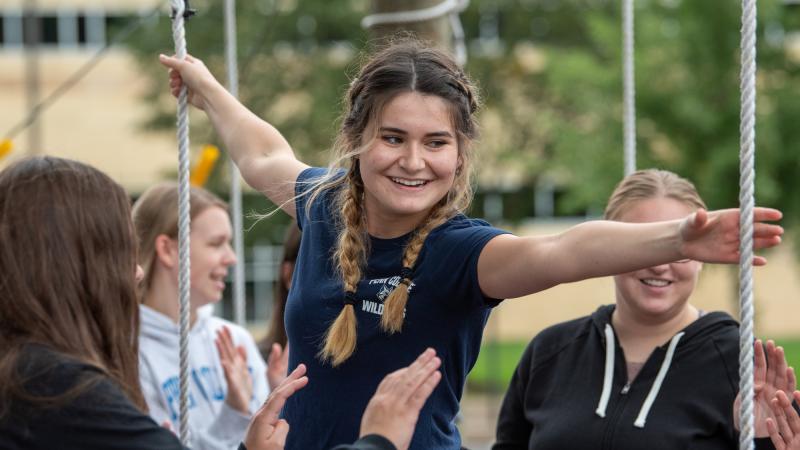 Dominique A. Viola, a May dental hygiene graduate, is spotted by her peers as she reaches for a rope. In its first year, the Challenge Course hosted 34 groups, including academic classes, student organizations, athletics teams and departmental staff.