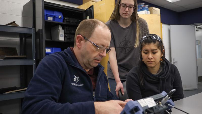 Mark N. Hurd, Penn College instructor of nondestructive testing and welding, walks students Jayna K. Vicary, center, and Ybarra, both 2022 graduates of welding & fabrication engineering technology, through use of ultrasonic testing equipment. 