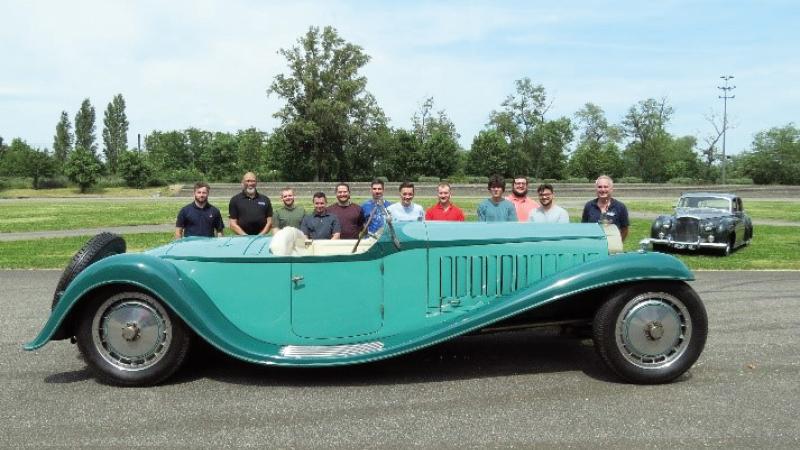 The class gathers behind a 1930 Bugatti Royale Esders Roadster at the Schlumpf collection in Mulhouse, France.