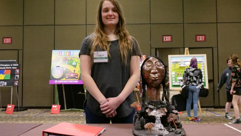Beaver shows her winning sculpture at SkillsUSA.