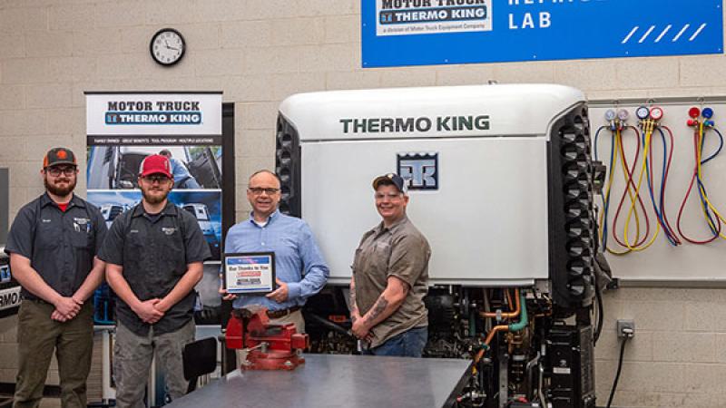 Frank Miller, executive vice president of Kenworth of Pennsylvania and Motor Truck Thermo King, gathers with Penn College diesel technology students in the Motor Truck Thermo King Refrigeration Lab. From left are Evan Buisch, of Arkport, N.Y.; Ryan J. Santora, of Norwalk, Conn.; Miller; and Nickolette Breauchy, of Jersey Shore.