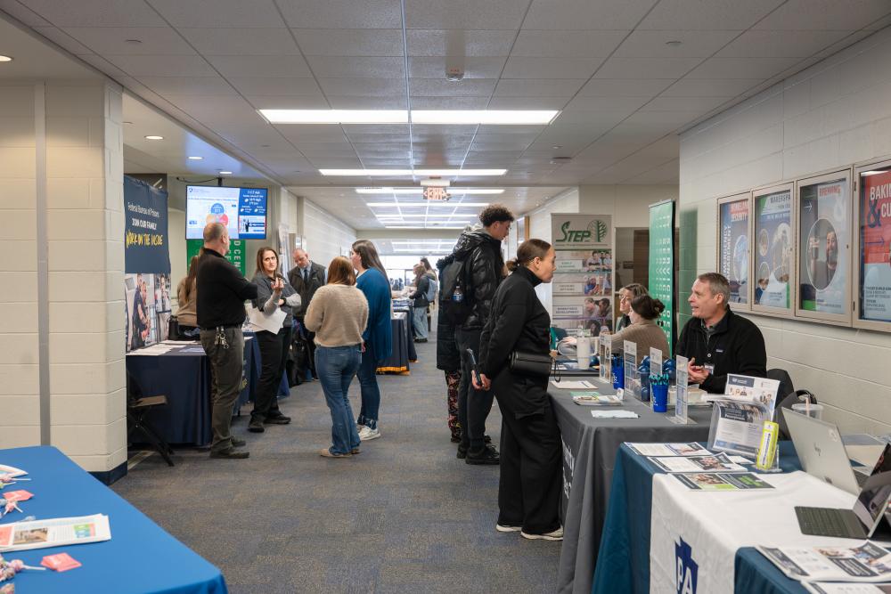 Information tables line a hallway in Penn College's Hager LIfelong Education Center.
