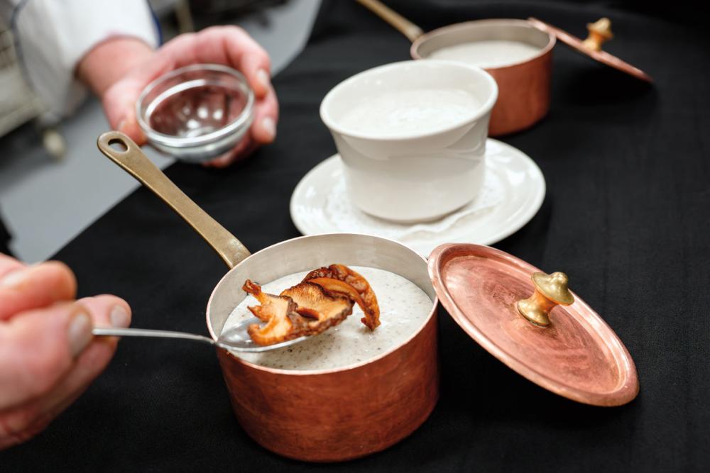 Chef Frank M. Suchwala garnishes his mushroom soup. For years, Suchwala and his students have been preparing the soup for the Central Pennsylvania Food Bank’s annual soup fundraisers.