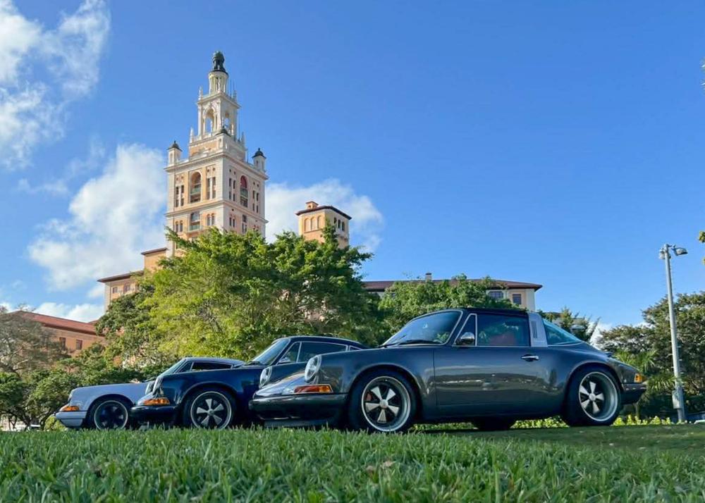 Luxury vehicles sit on the lawn of the Bilmore Hotel during Moda Miami.