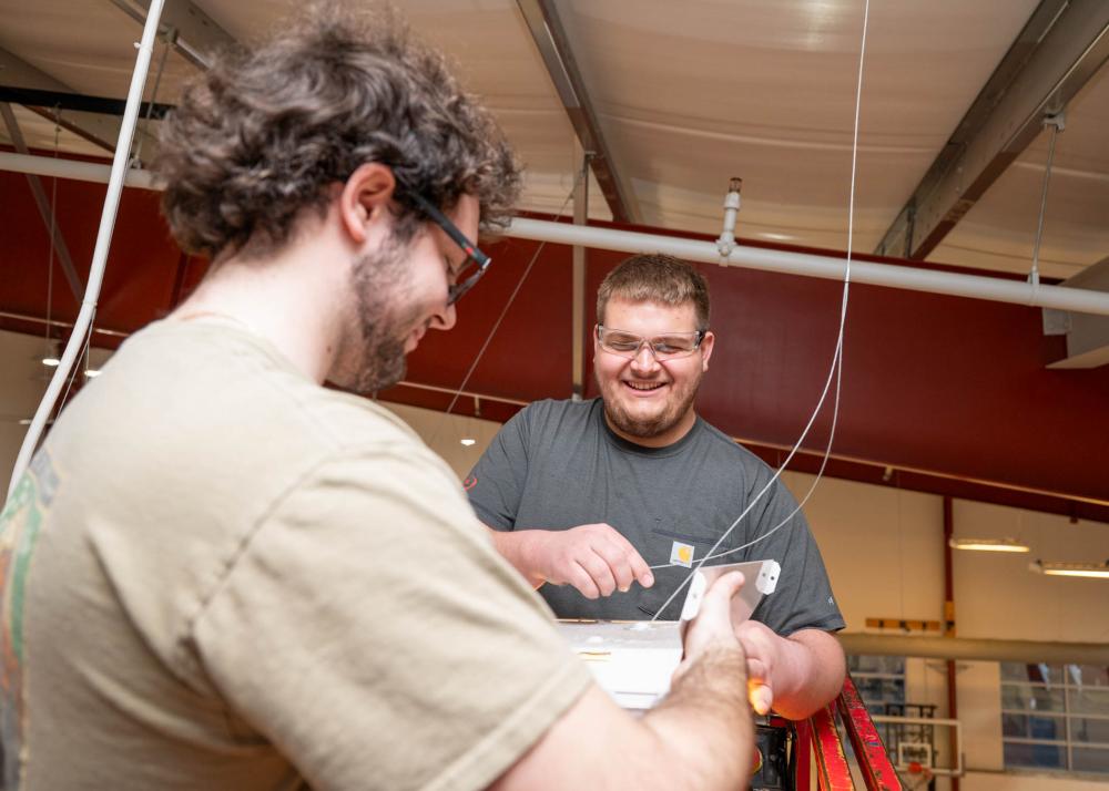 Two students work on an electrical project. 
