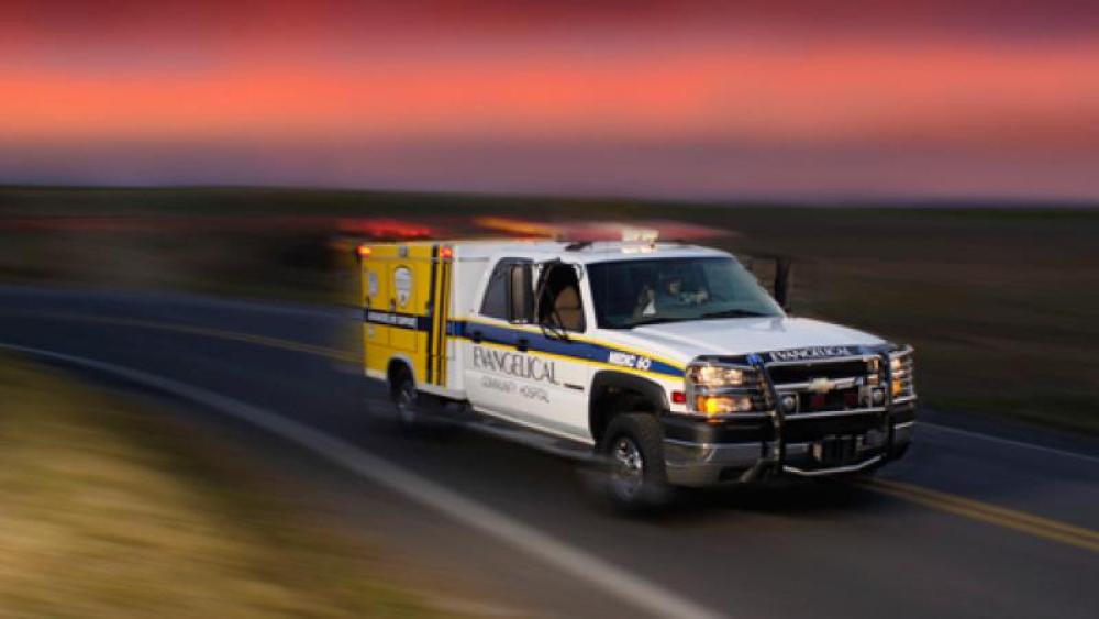 Ambulance in motion against a red sky