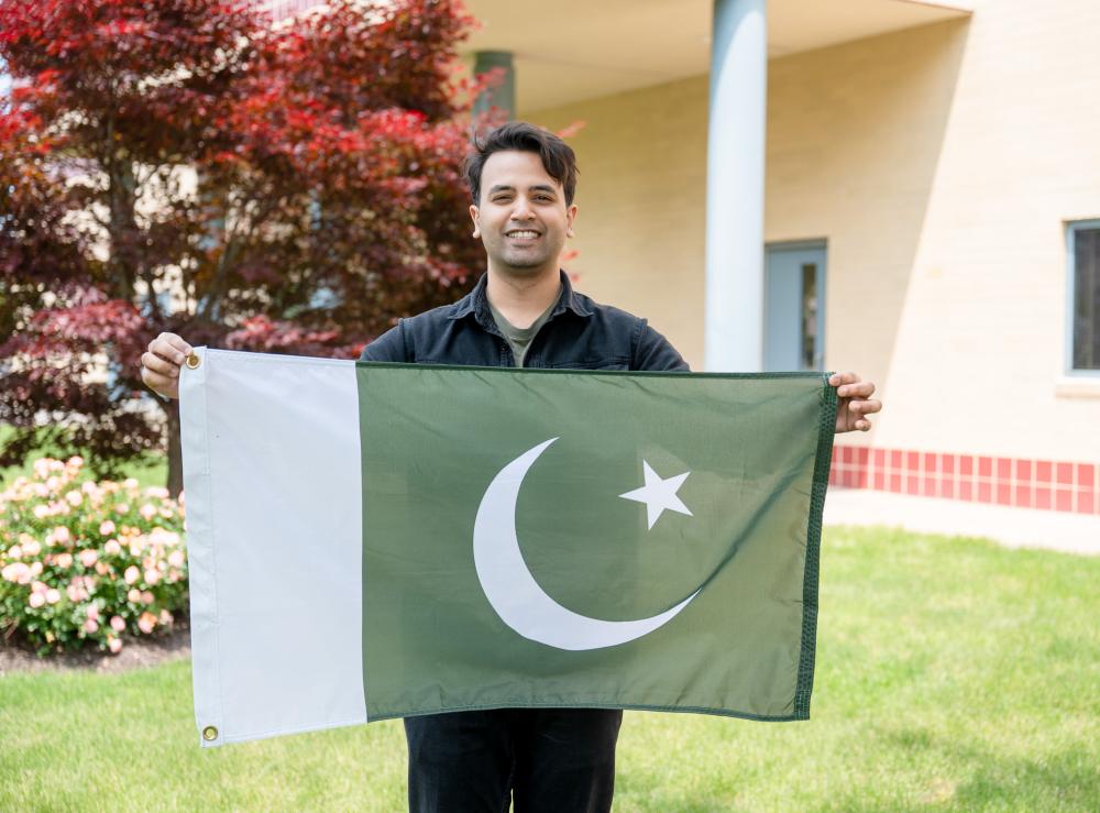 International student holding flag.