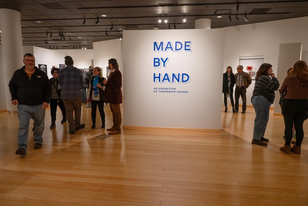 Gallery guest mill around the open Gallery space for the Made By Hand exhibit.