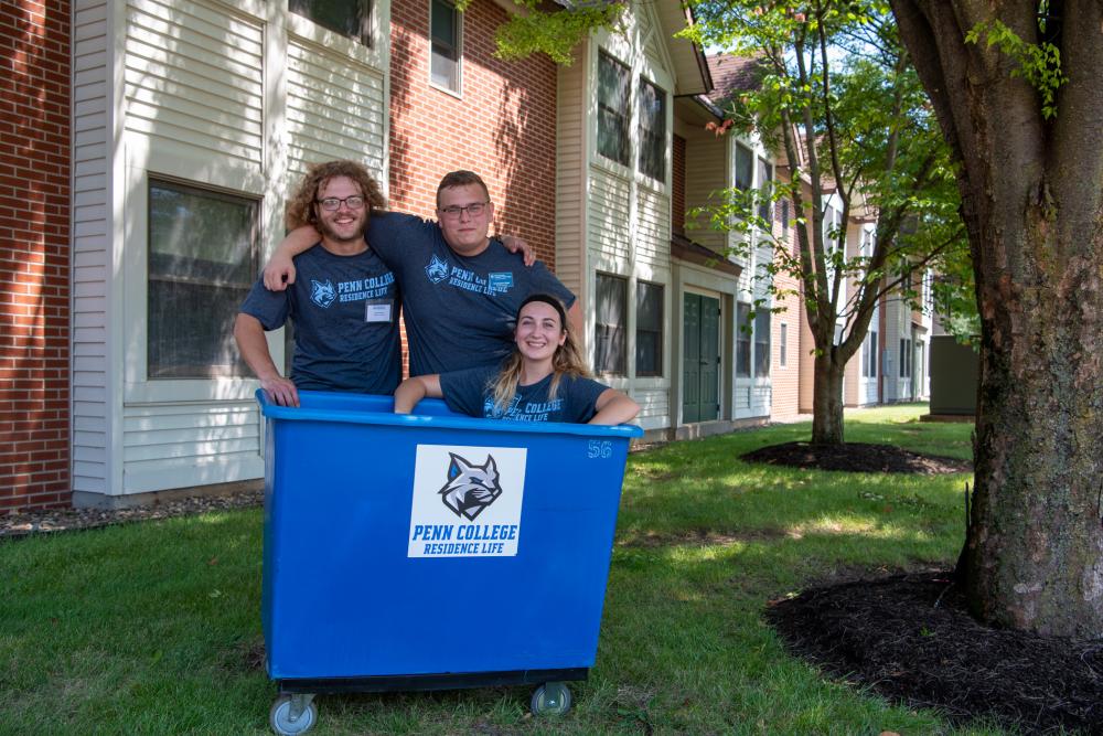 Students sitting inside delivery cart during welcome week