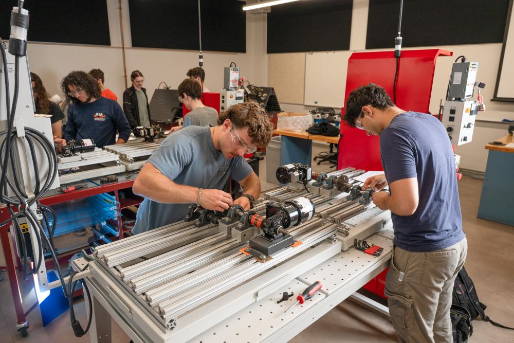 Students work on equipment in a Mechatronics lab
