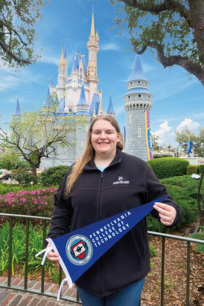 Corrina Blose, a pastry cook at Walt Disney World, pauses on her day off for a photo in front of the park’s iconic Cinderella Castle. The baking & pastry arts (2021) and applied management (2022) grad produces desserts and baked goods for several Magic Kingdom eateries.