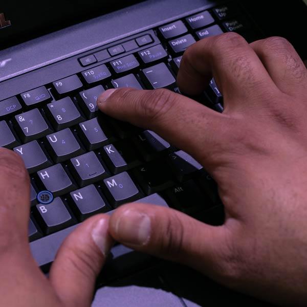 student typing on a keyboard