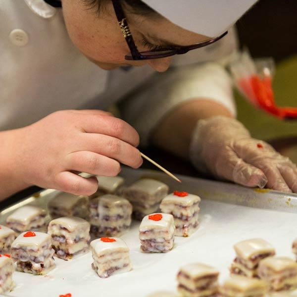 Penn College Baking & Pastry student works in a professional kitchen.