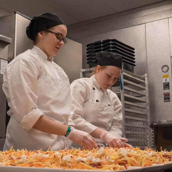 Penn College students participate in a hands‑on internship experience, working together in a professional kitchen.