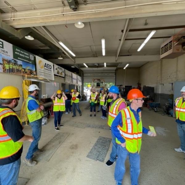 Donning safety vests and hard hats at the training site