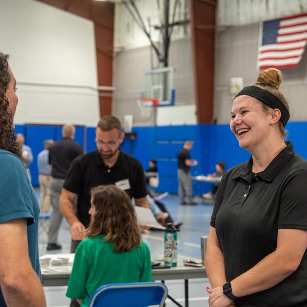 Human services alumna and bail release officer Bryssa A. Dunkleberger (right) enjoys conversation with Miller, her former professor.