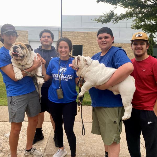 Happiness by the handful! Students enjoy the ample company of Groucho and Meatball, electrical technology/occupations instructor Eric L. Anstadt's pair of English bulldogs. From left are Gavin M. Ulsh, of Hummelstown, electrical technology; Edwin Villanueva Jr., Philadelphia, residential construction technology & management; Kayla A. Weinizierl, Summerhill, bachelor of architecture; Elijah J. Moyer, Quakertown, aviation maintenance technology; and Mason A. Cooper, engineering CAD technology.