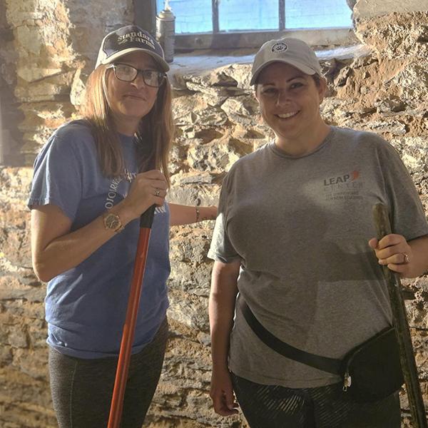 Brooms at the ready, Snyder (left) and Empet prepare to tackle the cobwebbed task at hand.