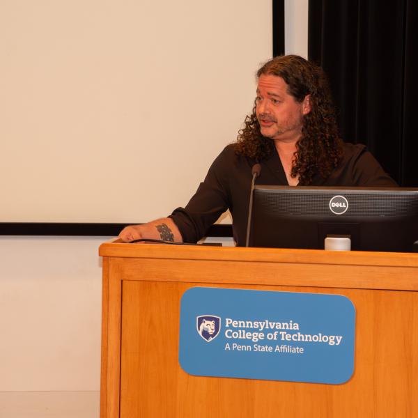 Miller introduces the presenter, before joining him on stage for a presentation that was as comfortably informal as it was intellectually satisfying.