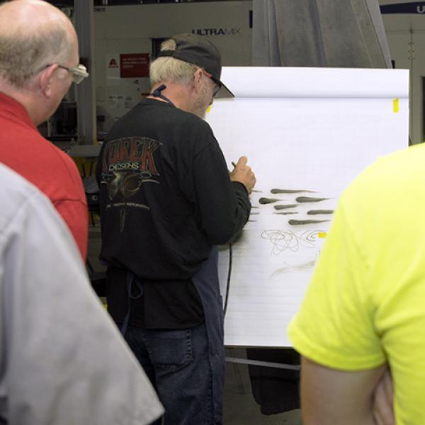 Stoll demonstrates how to paint a dagger (or rat tail) stroke, just one of the many steady-handed techniques he's perfected over the years.