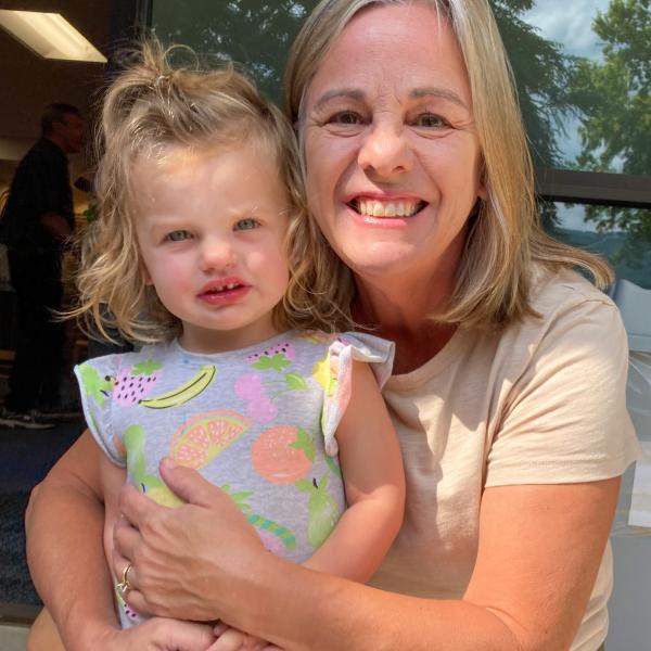 A grandmother poses with her granddaughter.