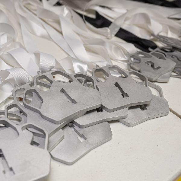 Student-made medals in the shape of Wildcat paws.