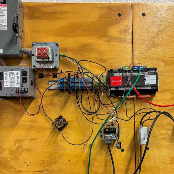 A fully wired electrical control and automation training panel.