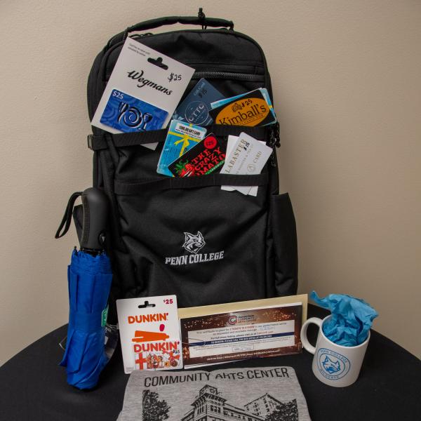 Gift basket with backpack, T-shirt and many gift cards.
