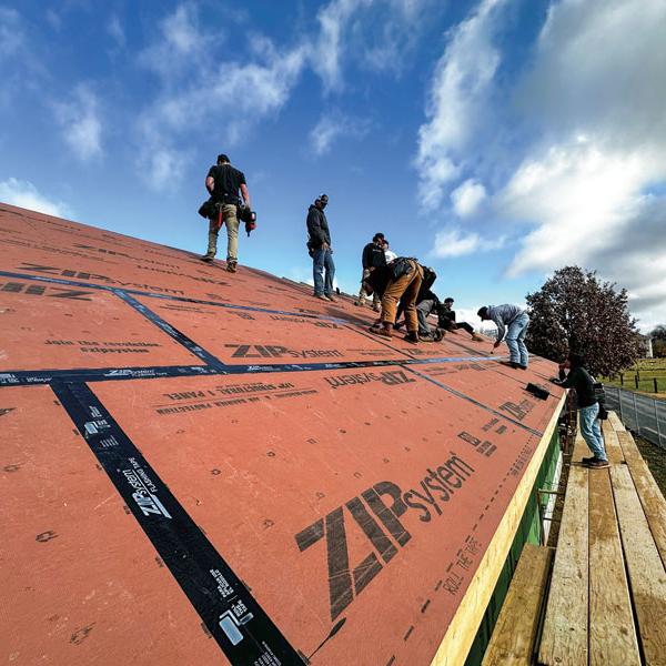 Students sheathe the roof.